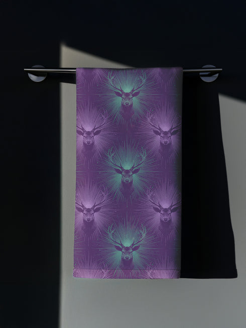 Set of four purple dining napkins featuring alternating teal and violet stag heads with radiating sunburst patterns, sized 18x18 inches.
